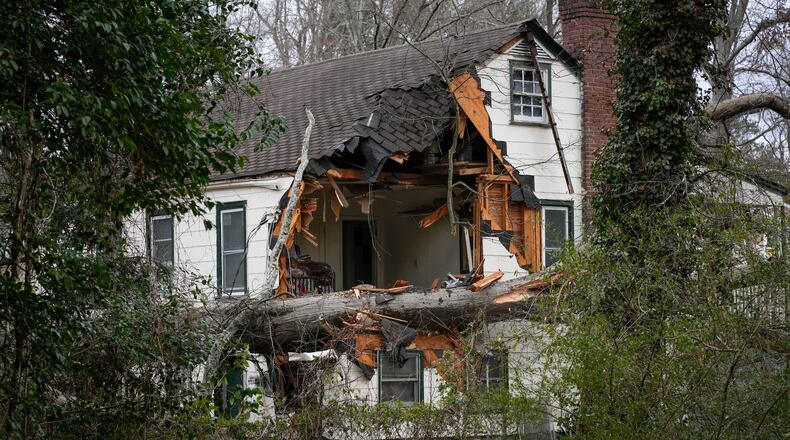 A fallen tree destroys a section of a home on Matilda Place in Atlanta.
