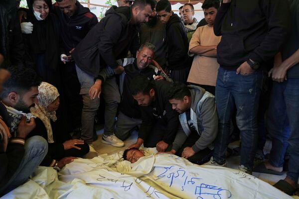 Palestinians mourn over the bodies of their relatives killed in an Israeli army airstrike, during their funeral in Khan Younis, southern Gaza Strip, Saturday, April 19, 2025. (AP Photo/Abdel Kareem Hana)