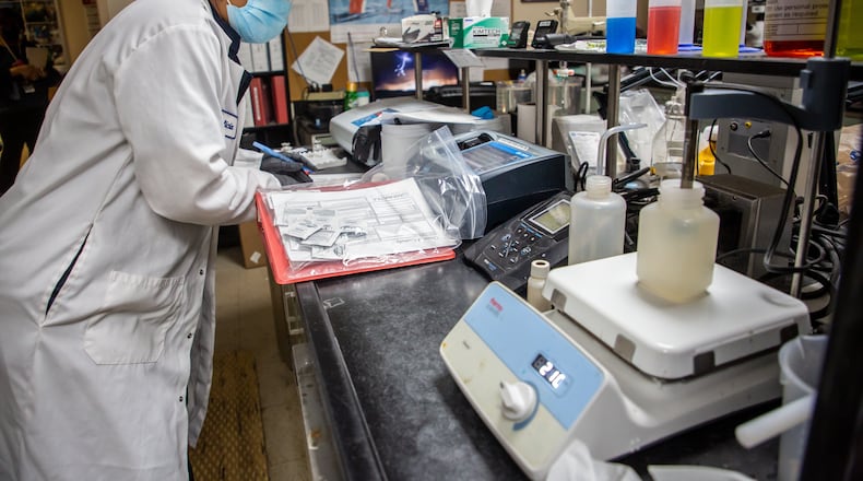 Felicia Jones, the senior lab technician at Senior lab technician at Snapwater Creek Treatment Plant in south DeKalb, tested a COVID-19 water sample for pH and temperature before preparing it for delivery Friday, March 18, 2022.  STEVE SCHAEFER FOR THE ATLANTA JOURNAL-CONSTITUTION