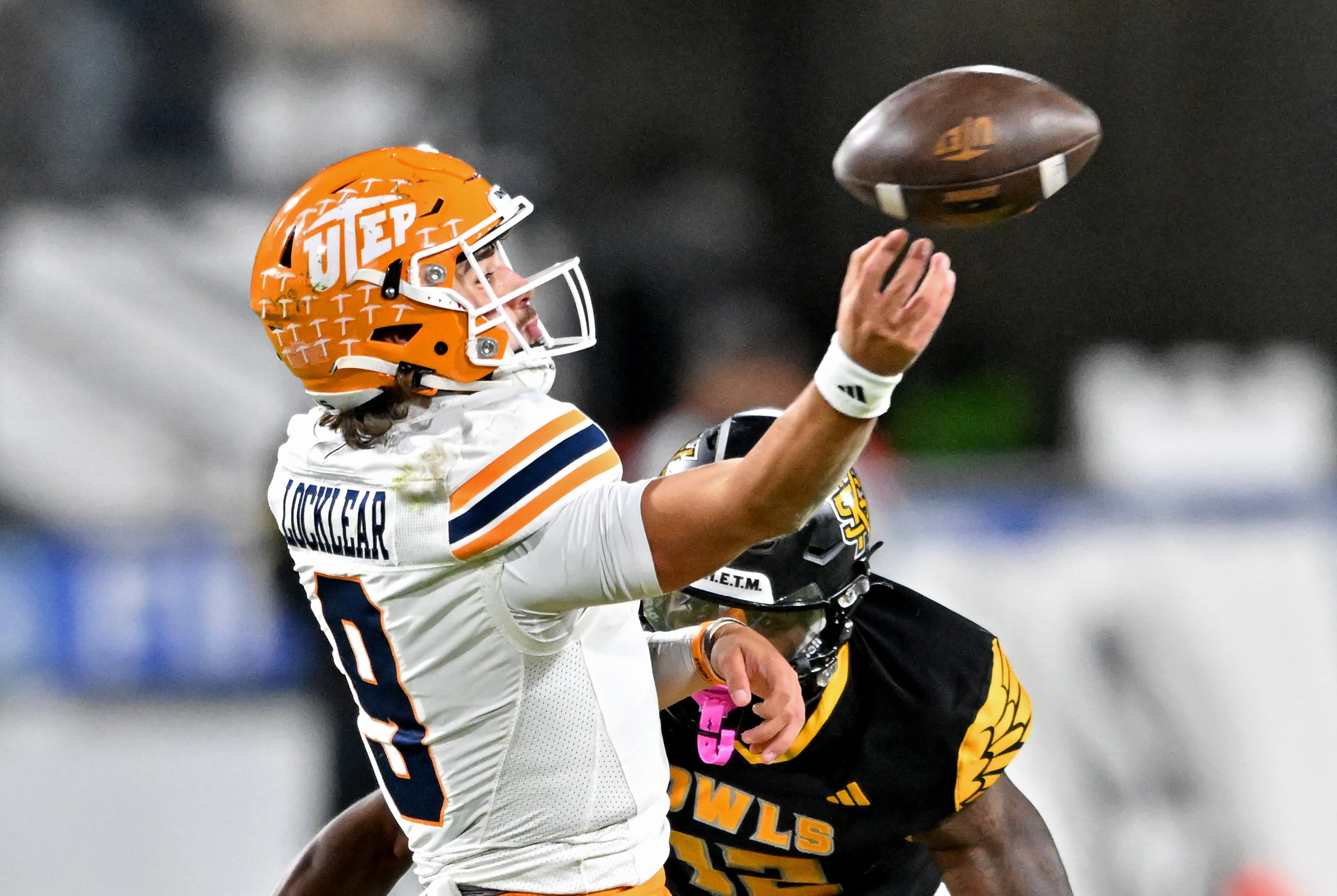 UTEP quarterback Skyler Locklear (9) gets off a pass under pressure from Kennesaw State defensive back Kody Jones (12) during the first half in an NCAA college football game at Fifth Third Stadium, Tuesday, October 28, 2025 in Kennesaw. (Hyosub Shin / AJC)