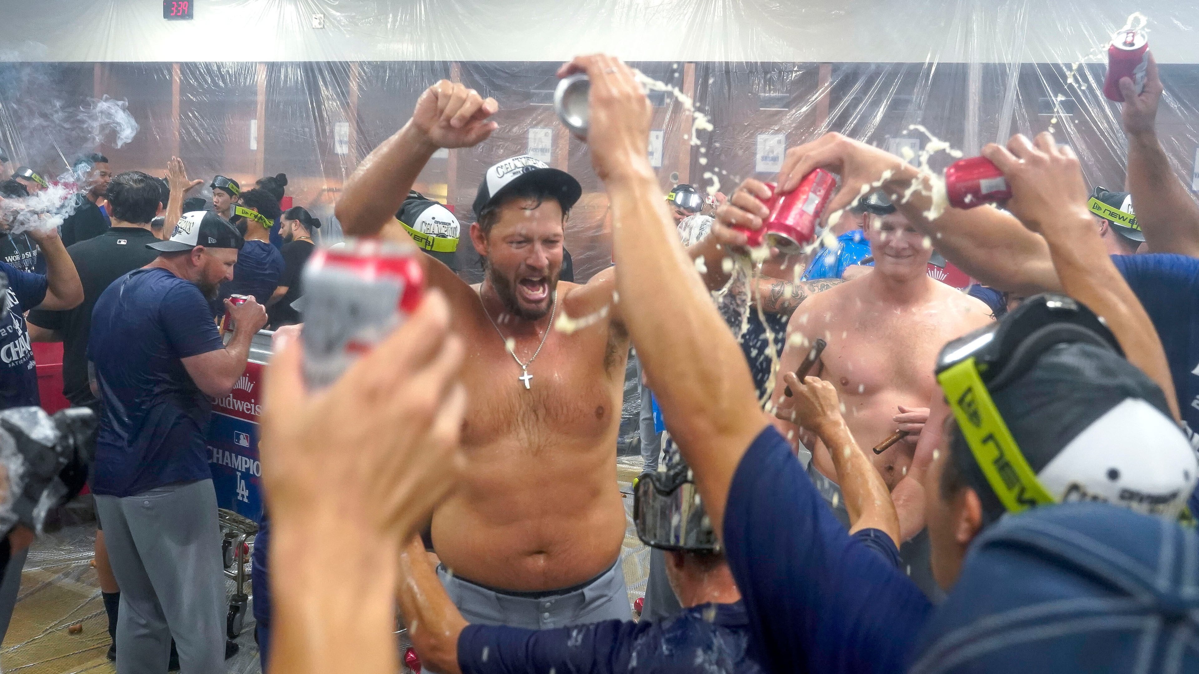 Los Angeles Dodgers pitcher Clayton Kershaw, center, celebrates with his teammates after the Dodgers clinched the National League West title against the Arizona Diamondbacks during a baseball game at Chase Field Thursday, Sept. 25, 2025, in Phoenix. (AP Photo/Darryl Webb)