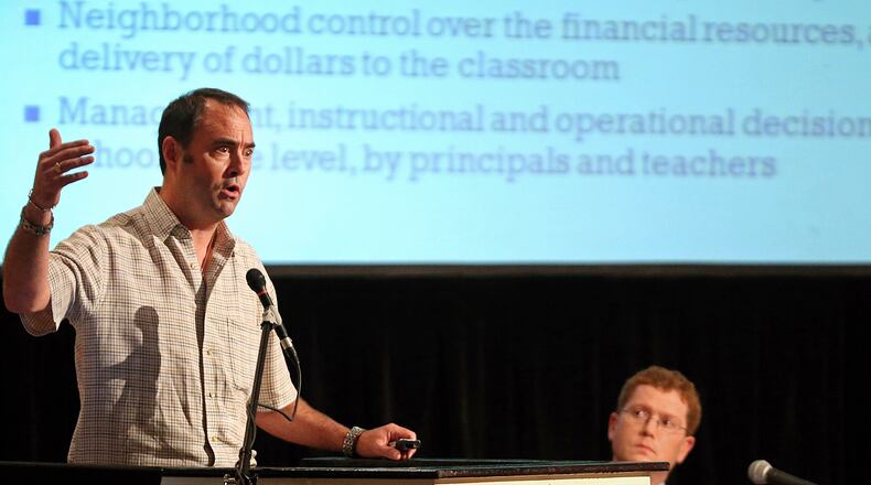 LEDE PHOTO: August 20, 2013 - Atlanta, Ga: Matthew Lewis, left, speaks about the Druid Hills Charter Cluster as President of the Druid Hills Civic Association Justin Critz, right, listens during a Druid Hills town hall meeting at Glenn Memorial United Methodist Church Tuesday night in Atlanta, Ga., August 20, 2013. Matthew Lewis is leading a revolution of sorts: he's the main guy behind what could become the first charter school "cluster" in Georgia. JASON GETZ / JGETZ@AJC.COM