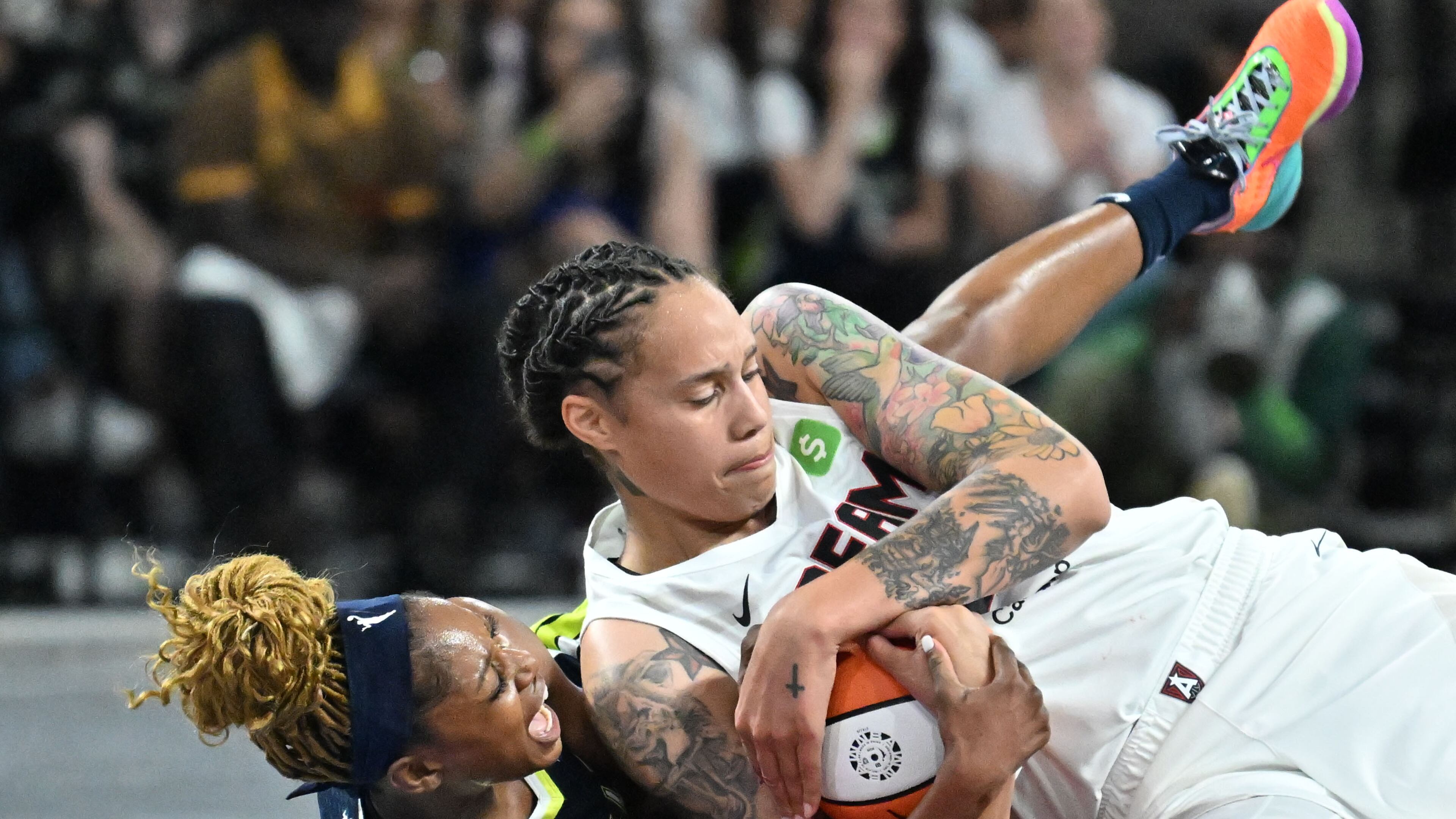 Atlanta Dream center Brittney Griner (right) and Dallas Wings guard Kaila Charles (left) fight for the loose ball during the second half in a WNBA basketball game at Gateway Center Arena, Saturday, May 24, 2025, in Atlanta. Atlanta Dream won 83-75 over Dallas Wings. (Hyosub Shin / AJC)