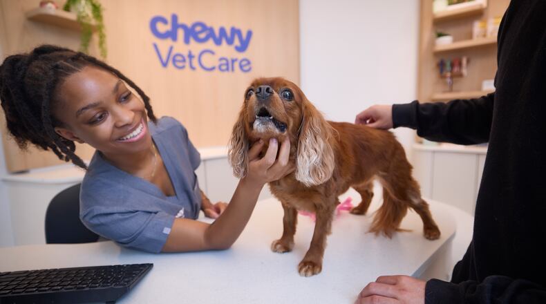 Chewy, which made its name as an online retailer of pet food and pet products, has opened two in-person vet centers in metro Atlanta. Here in the Dunwoody location, a three-way interaction -- a customer, a pet and the client concierge.