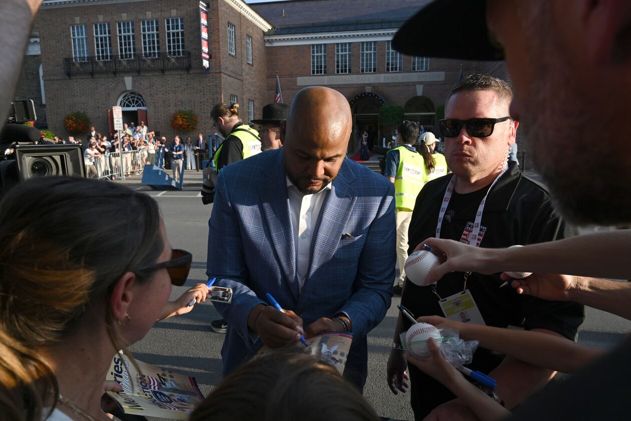 Andruw Jones signs autographs during Hall of Fame Legends Parade on Saturday, July 25, 2026, in Cooperstown, N.Y. Andruw Jones will be inducted into the National Baseball Hall of Fame on Sunday as part of the Class of 2026, alongside Carlos Beltrán and Jeff Kent. (Hyosub Shin/AJC)