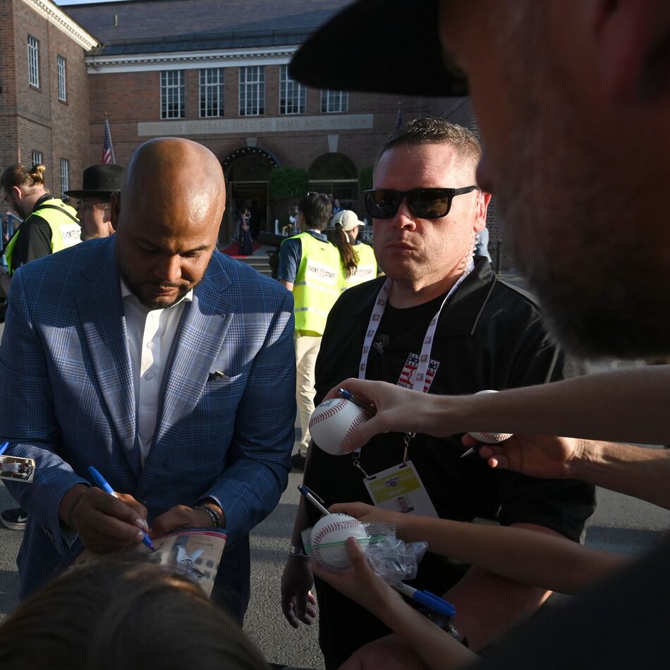 Former Brave Andruw Jones signs autographs during the Hall of Fame Legends Parade on Saturday, July 25, 2026, in Cooperstown, N.Y. Jones will be inducted into the National Baseball Hall of Fame on Sunday as part of the Class of 2026, alongside Carlos Beltrán and Jeff Kent. (Hyosub Shin/AJC)