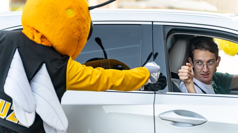 Jack Rumpf, an incoming first-year from Athens, fist-bumps Buzz, Georgia Tech’s mascot, while entering the Campus Recreation Center Parking Deck to check in for move-in on Georgia Tech's campus in Atlanta on Saturday, August 10, 2024. (Seeger Gray / AJC)