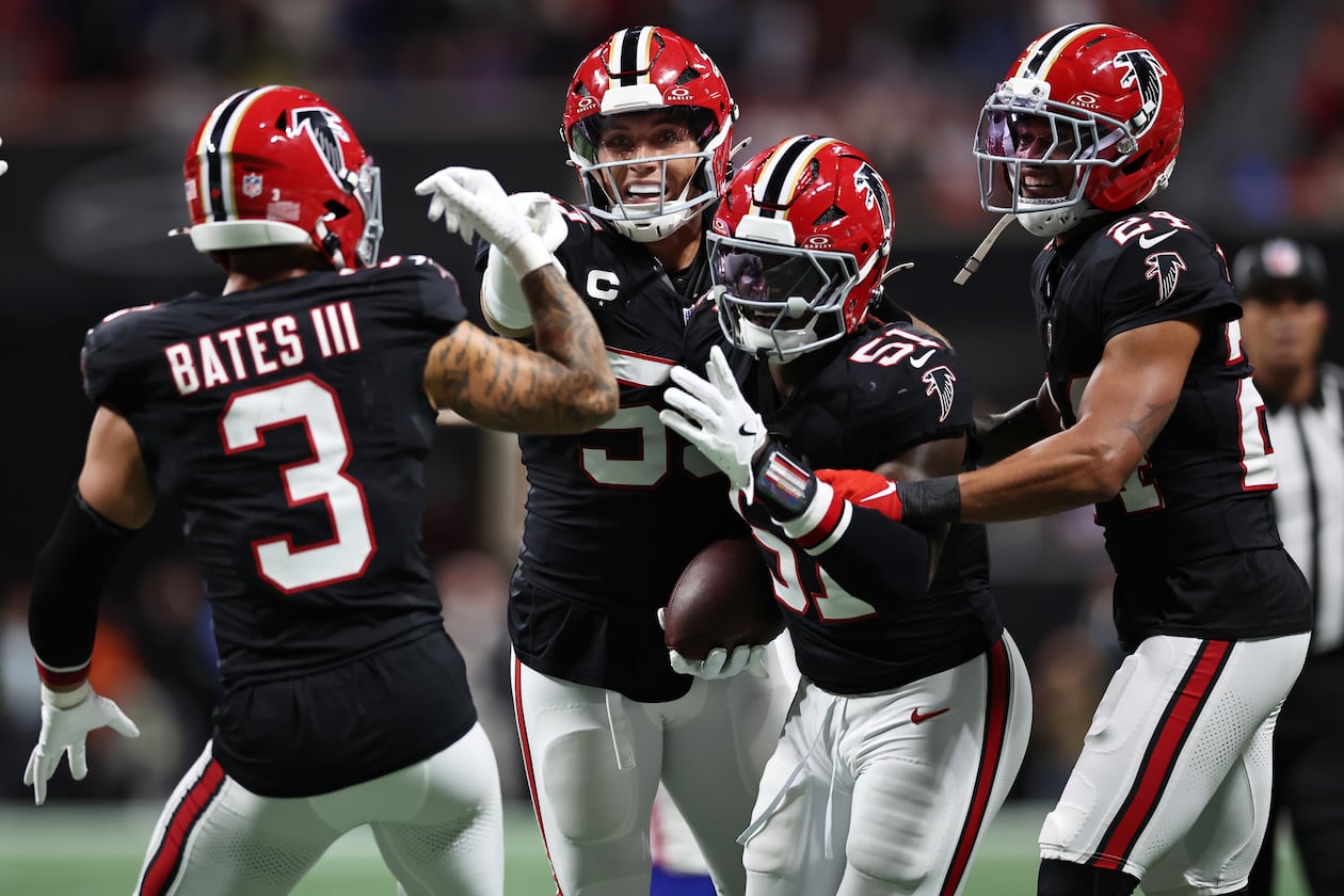 Falcons linebacker Deangelo Malone (right center) — pictured celebrating his game-clinching interception against the Bills on Oct. 13 — is headed to injured reserve with a broken ankle. (Colin Hubbard/AP)