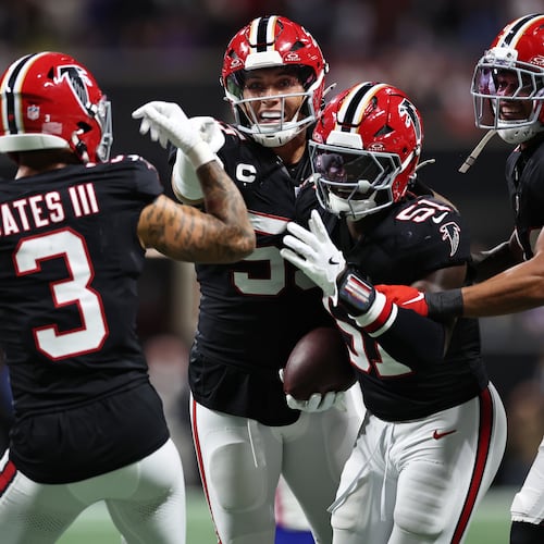Falcons linebacker Deangelo Malone (right center) — pictured celebrating his game-clinching interception against the Bills on Oct. 13 — is headed to injured reserve with a broken ankle. (Colin Hubbard/AP)