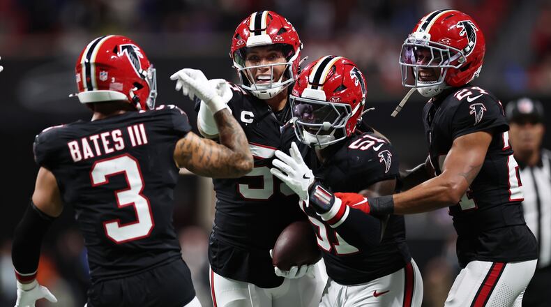 Falcons linebacker Deangelo Malone (right center) — pictured celebrating his game-clinching interception against the Bills on Oct. 13 — is headed to injured reserve with a broken ankle. (Colin Hubbard/AP)