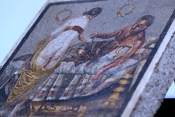 A Roman mosaic depicting a pair of lovers, which was repatriated from Germany, is displayed to journalists in the auditorium of Pompeii archaeological park, Tuesday, July 15, 2025. (AP Photo/Gregorio Borgia)