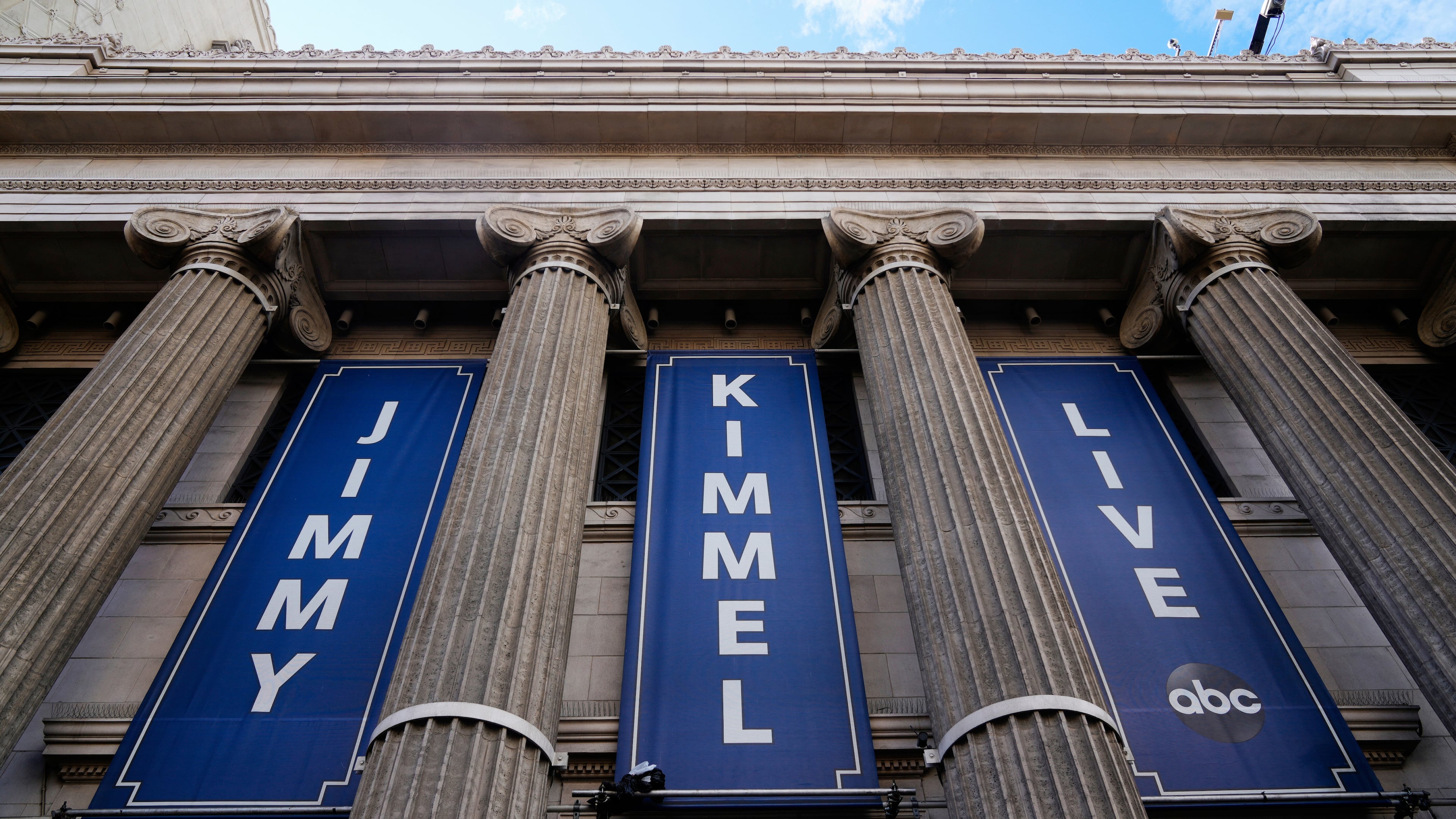 Banners are placed outside the El Capitan Entertainment Centre, where Jimmy Kimmel Live! is filmed, on Thursday, Sept. 18, 2025, in Los Angeles. (AP Photo/Damian Dovarganes)