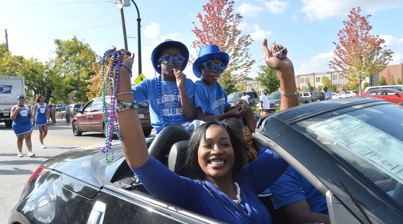 Booker T. Washington High School Principal Tasharah Wilson, shown here in a 2014 parade with her twin sons, plans to leave the high school to launch a new college and career academy. HYOSUB SHIN / HSHIN@AJC.COM
