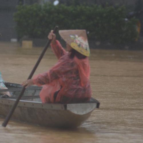 People paddle a boat on a flooded street in Hue, Vietnam, Tuesday, Oct. 28, 2025. (Van Dung/VNA via AP)