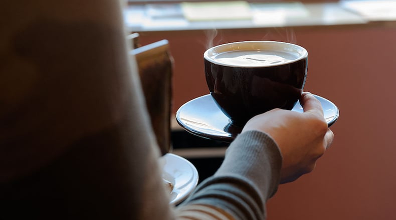 BROOKLYN, NY - FEBRUARY 22: A customer carries a cup of coffee to her table at Colson Patisserie on February 22, 2016 in the Brooklyn borough of New York City. A recently released study found that drinking two cups of coffee a day decreases one's chance of developing liver cirrhosis by 44 percent.
(Photo by Bryan Thomas/Getty Images)
