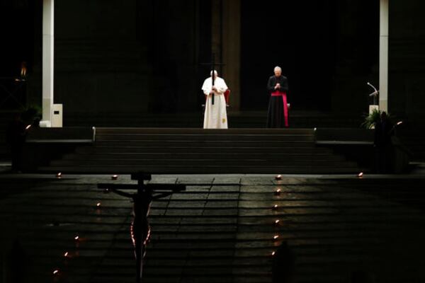 FILE - Pope Francis presides over the Via Crucis – or Way of the Cross – ceremony in St. Peter's Square, empty of the faithful following Italy's ban on gatherings to contain the COVID-19 contagion, at the Vatican, Friday, April 10, 2020. (AP Photo/Alessandra Tarantino, file)