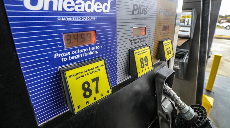 Motorists fuel up at a QuikTrip in Cobb County on Friday as gas prices rose in response to the Russian invasion of Ukraine. Russia produces 11% of the world's crude oil. (John Spink / John.Spink@ajc.com)