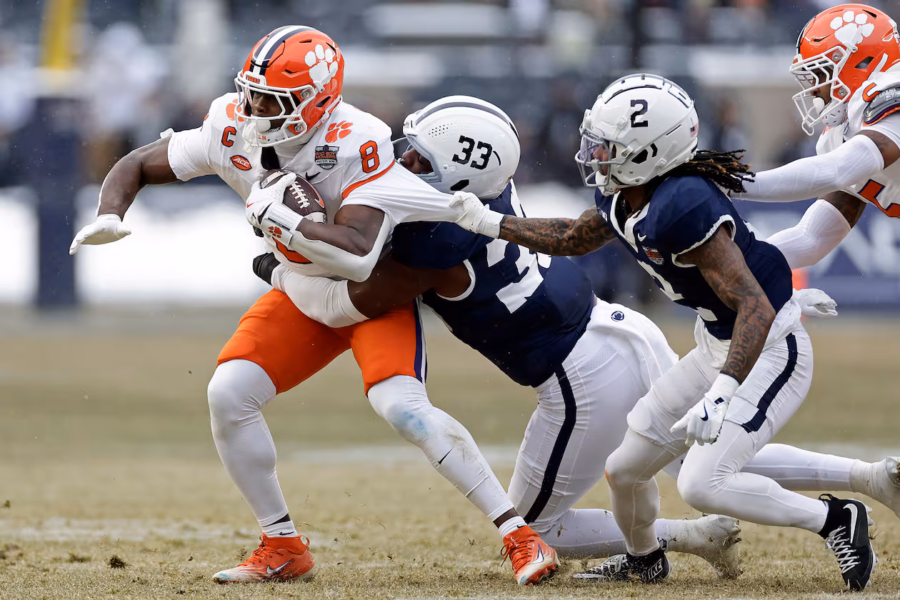 Clemson running back Adam Randall is tackled by Penn State cornerback Audavion Collins and defensive end Dani Dennis-Sutton during the first half of the Pinstripe Bowl at Yankee Stadium in December. (Adam Hunger/AP 2025)