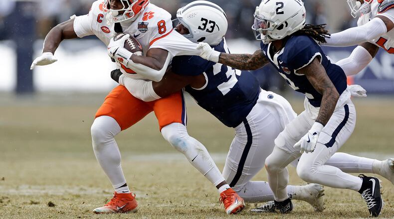 Clemson running back Adam Randall is tackled by Penn State cornerback Audavion Collins and defensive end Dani Dennis-Sutton during the first half of the Pinstripe Bowl at Yankee Stadium in December. (Adam Hunger/AP 2025)