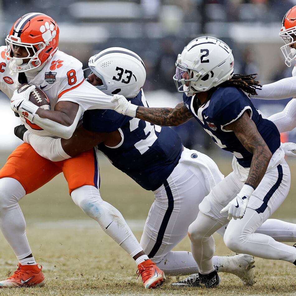 Clemson running back Adam Randall is tackled by Penn State cornerback Audavion Collins and defensive end Dani Dennis-Sutton during the first half of the Pinstripe Bowl at Yankee Stadium in December. (Adam Hunger/AP 2025)
