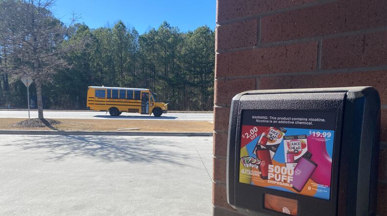 A gas station in Lawrenceville advertises fruit-flavored disposable vape devices. The devices are not authorized for sale by the U.S. Food and Drug Administration. The gas station is near three Gwinnett County high schools. (Josh Reyes / Josh.Reyes@ajc.com)