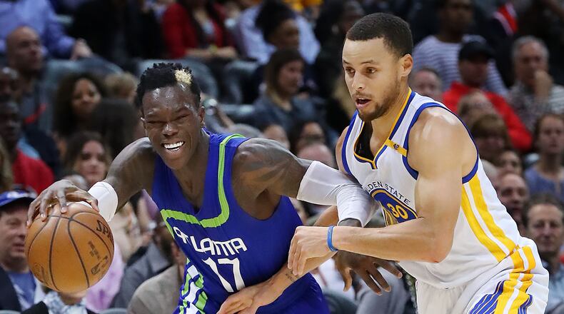 Atlanta Hawks guard Dennis Schroder takes it to the basket battling Golden State Warriors guard Stephen Curry on his way to two of his 19 first period points in a NBA basketball game on Monday, March 6, 2017, in Atlanta. Curtis Compton/ccompton@ajc.com