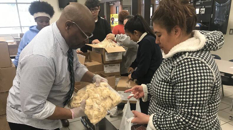 Graves Elementary School became the first school in Gwinnett County to offer a monthly food pantry to the community. At its inagural event on Jan. 23, about 70 families came to “shop” for staples. Each family received 40 to 50 pounds of groceries with about 25% consisting of fresh produce. In partnership with the Atlanta Community Food Bank, the program is another resource the school has to serve the needs of its children. COURTESY OF GRAVES ELEMENTARY