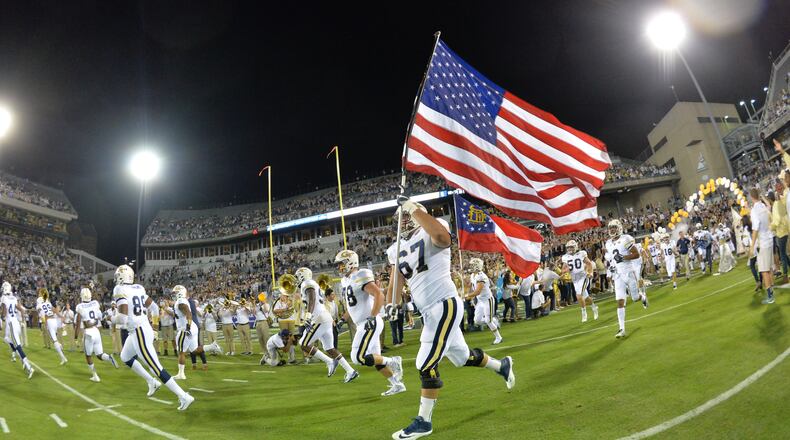 October 21, 2017 Atlanta - Georgia Tech's Ramblin' Wreck leads the band, cheerleaders, Buzz, players, and coaches before the start of the Georgia Tech home game against the Wake Forest during an NCAA college football game at Bobby Dodd Stadium on Saturday, October 21, 2017. HYOSUB SHIN / HSHIN@AJC.COM