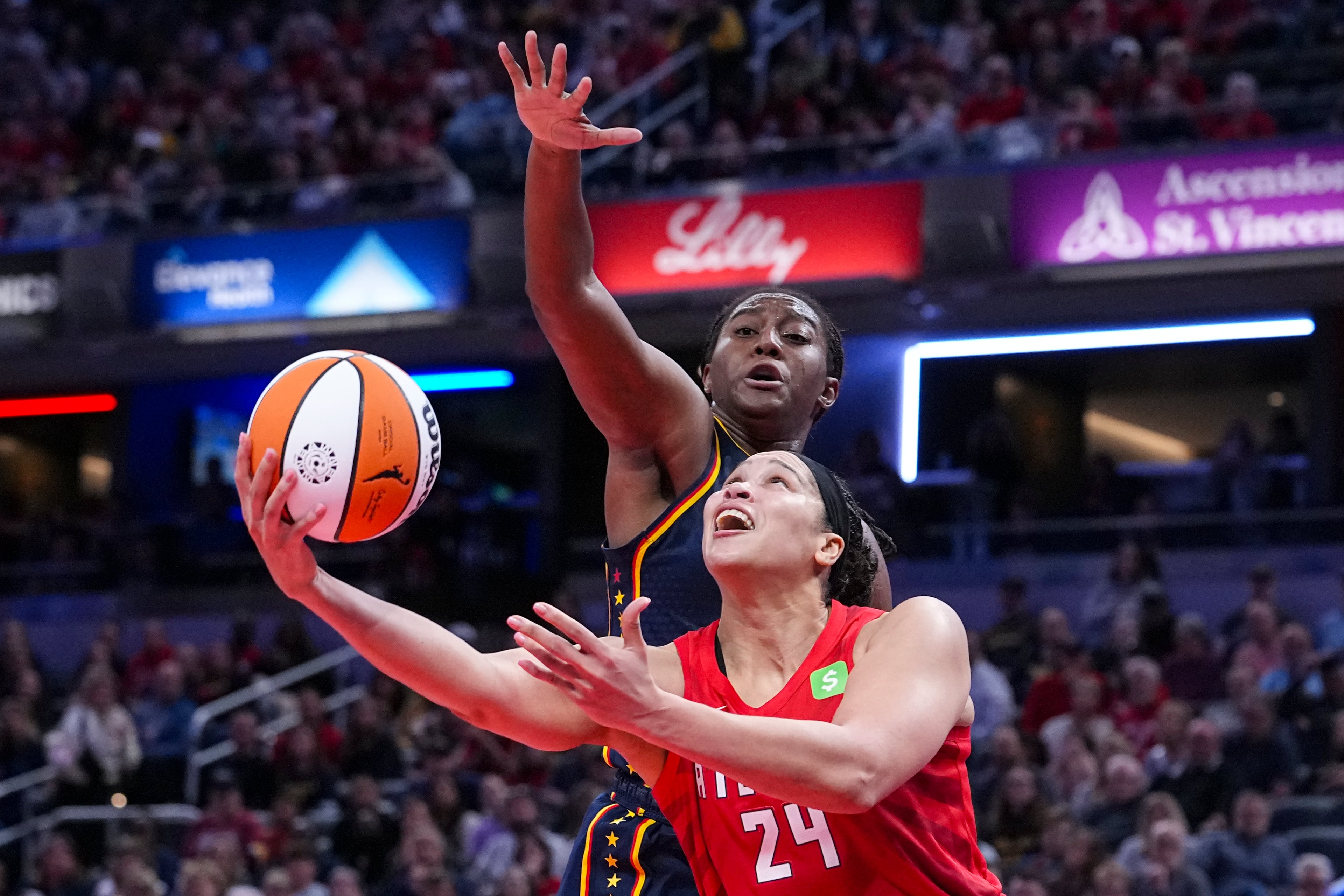 Atlanta Dream forward Brionna Jones (24) shoots in front of Indiana Fever forward Aliyah Boston (7) in the second half of a WNBA basketball game in Indianapolis, Tuesday, May 20, 2025. (AP Photo/Michael Conroy)
