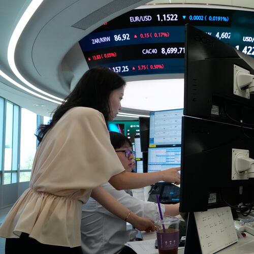 Currency traders watch monitors at the foreign exchange dealing room of the Hana Bank headquarters in Seoul, South Korea, Friday, Aug. 7, 2026. (AP Photo/Ahn Young-joon)