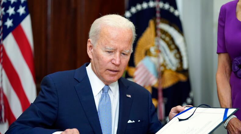 FILE - President Joe Biden signs into law S. 2938, the Bipartisan Safer Communities Act gun safety bill, in the Roosevelt Room of the White House in Washington, June 25, 2022. (AP Photo/Pablo Martinez Monsivais, File)