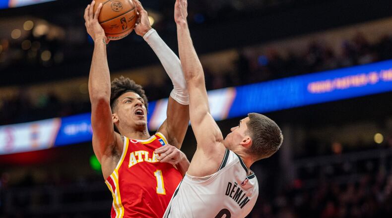 Atlanta Hawks forward Jalen Johnson attempts a basket over Brooklyn Nets guard Egor Dëmin during the first half of Sunday's game. (Erik Rank/AP)