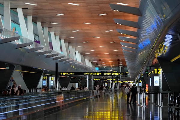 FILE - Passengers walk at Hamad International Airport in Doha, Qatar, Nov. 10, 2022. (AP Photo/Hassan Ammar, File)