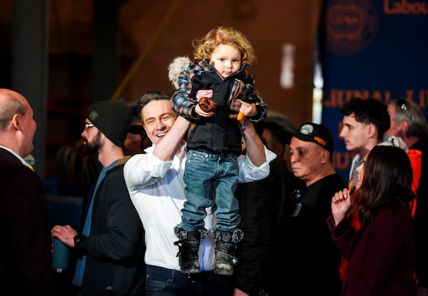 FILE - Conservative Leader Pierre Poilievre lifts his son Cruz up after speaking at a pre-election event in Ottawa, on March 21, 2025. (Justin Tang /The Canadian Press via AP, File)