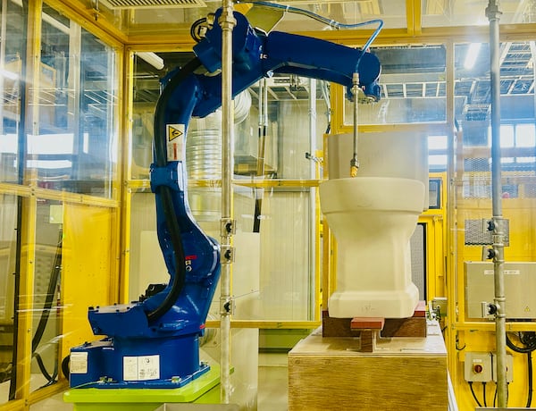 Robots spray compressed air to remove dust from toilets at Toto's Morrow plant. (Courtesy of Toto USA)