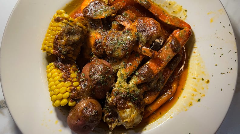 Combo No. 1 at the Seafood Menu includes a snow crab cluster, six steamed shrimp, corn and potatoes. Henri Hollis/henri.hollis@ajc.com