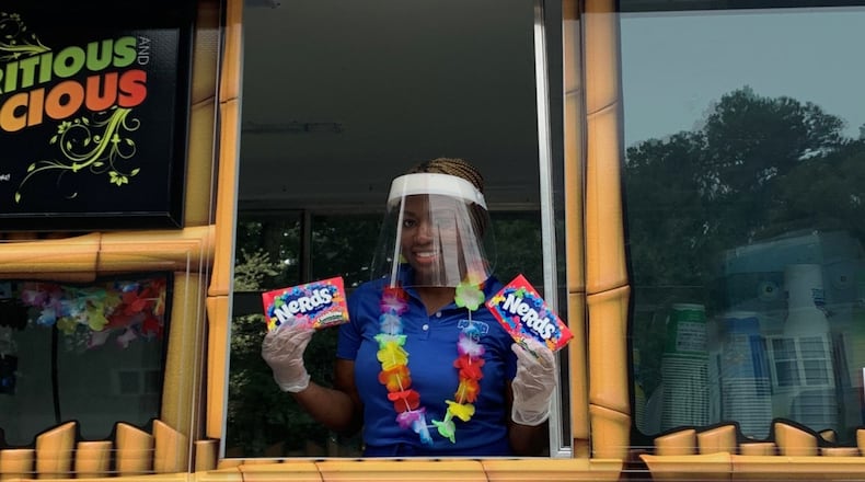 Quanesha Jackson, owner of Kona Ice of SW Atlanta prepares to serve icy treats to members of her community. Courtesy of Kona Ice of SW Atlanta