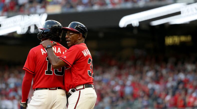 Atlanta Braves third base coach Ron Washington (37) talks with center fielder Ronald Acuna (13) after Acuna reached third base in the seventh inning Friday, Oct. 4, 2019, against the St. Louis Cardinals at SunTrust Park in Atlanta.