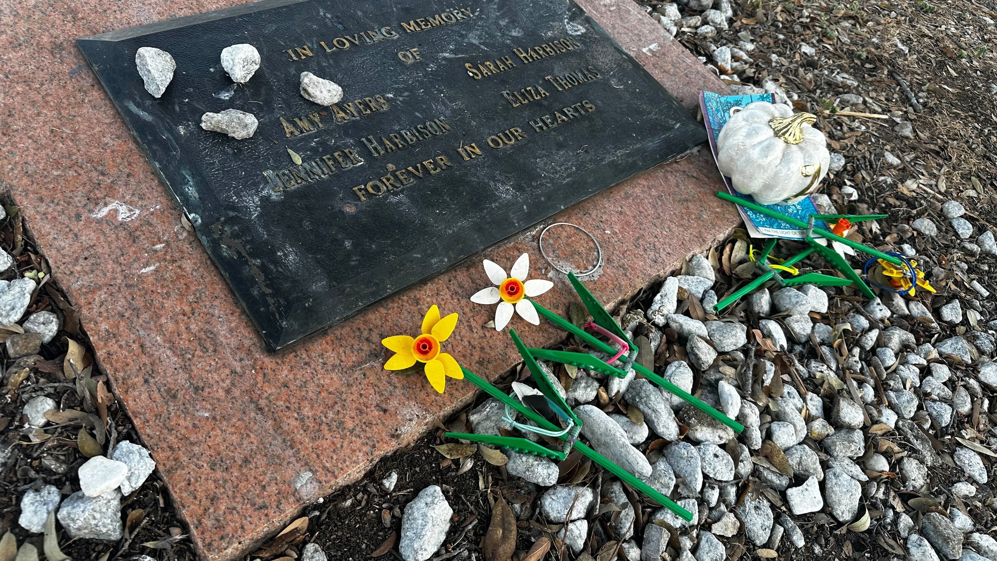 Tributes lay on a memorial Friday, Sept. 26, 2025, for four teenage girls who were killed in a yogurt shop in 1991 in Austin, Texas. (AP Photo/Paul J. Weber)