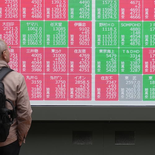 A person looks at an electronic stock board showing Japan's Nikkei index at a securities firm Tuesday, Nov. 25, 2025, in Tokyo. (AP Photo/Eugene Hoshiko)