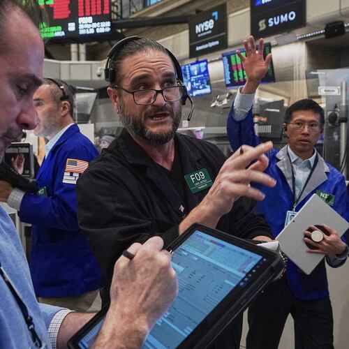 Chris Dattolo, center, works with fellow options traders on the floor of the New York Stock Exchange, Thursday, Jan. 22, 2026. (AP Photo/Richard Drew)
