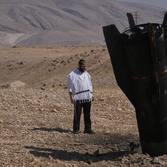 A man look at the wreckage of an Iranian missile that landed near the West Bank city of Jericho Monday, June 8, 2026. (AP Photo/Mahmoud Illean)