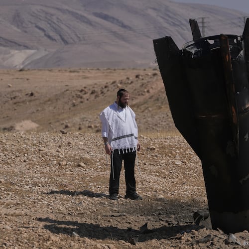 A man look at the wreckage of an Iranian missile that landed near the West Bank city of Jericho Monday, June 8, 2026. (AP Photo/Mahmoud Illean)