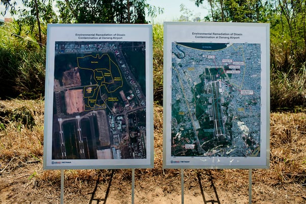 FILE- Maps of the area contaminated with dioxin around Danang airport are displayed during a ceremony marking the start of a project to clean up dioxin left over from the Vietnam War, at a former U.S. military base in Danang, Vietnam Thursday Aug. 9, 2012. (AP Photo/Maika Elan, File)