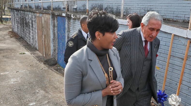 January 9, 2020 - Atlanta - Mayor Keisha Lance Bottoms and Arthur Blank, Chair, Arthur M. Blank Family Foundation,  walk by the abandoned apartments where the project will be built.  They were among those to speak at the Atlanta Police Recruit Housing Ground Breaking Ceremony in English Avenue.  Also present were Councilmember Andre Dickens, Todd Coyt, Assistant Chief of Atlanta Police,  and Dave Wilkinson, President & CEO, Atlanta Police Foundation.    Bob Andres / bandres@ajc.com