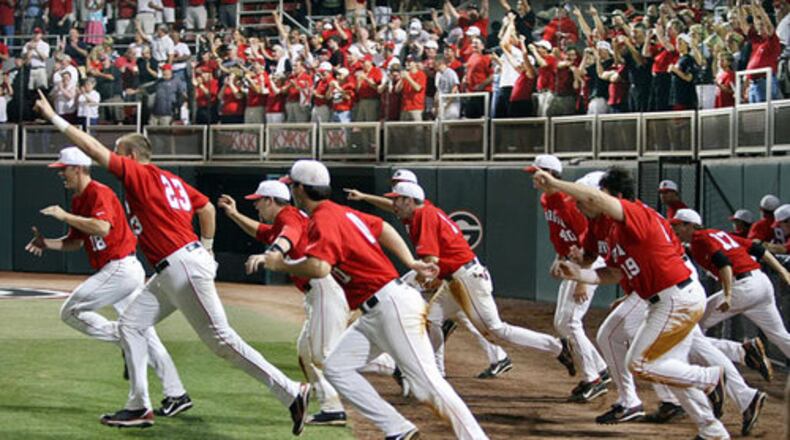 The Bulldogs charge the field to celebrate their 18-6 victory over rival Georgia Tech in their NCAA regional championship game at Foley Field in Athens on Monday.