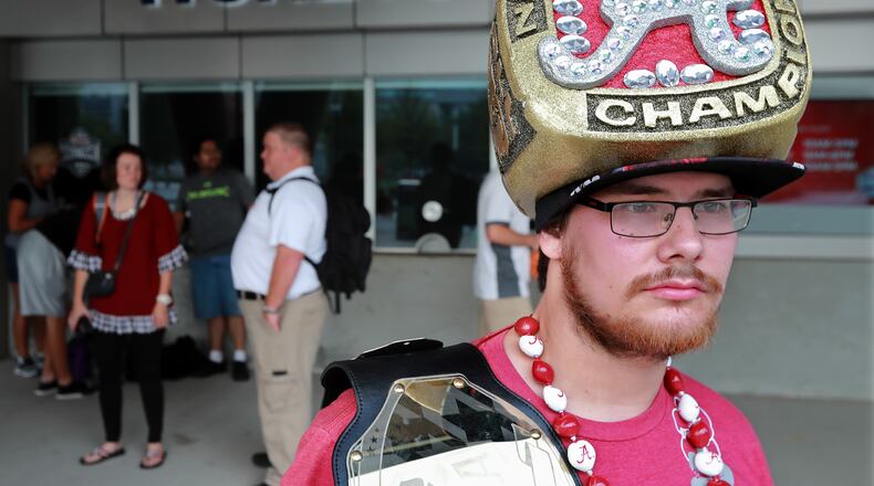 Alabama fan Shannon Villa, Birmingham, sports a national championship ring hat while waiting outside for the ticket window to open for SEC Media Days at the College Football Hall of Fame.