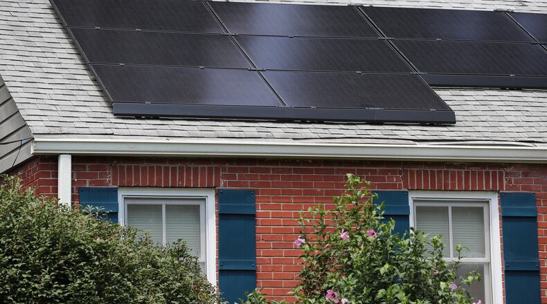 Cities and individuals around Georgia, such as the owners of this Decatur home with solar panels, are working toward clean energy. (Curtis Compton / ccompton@ajc.com)