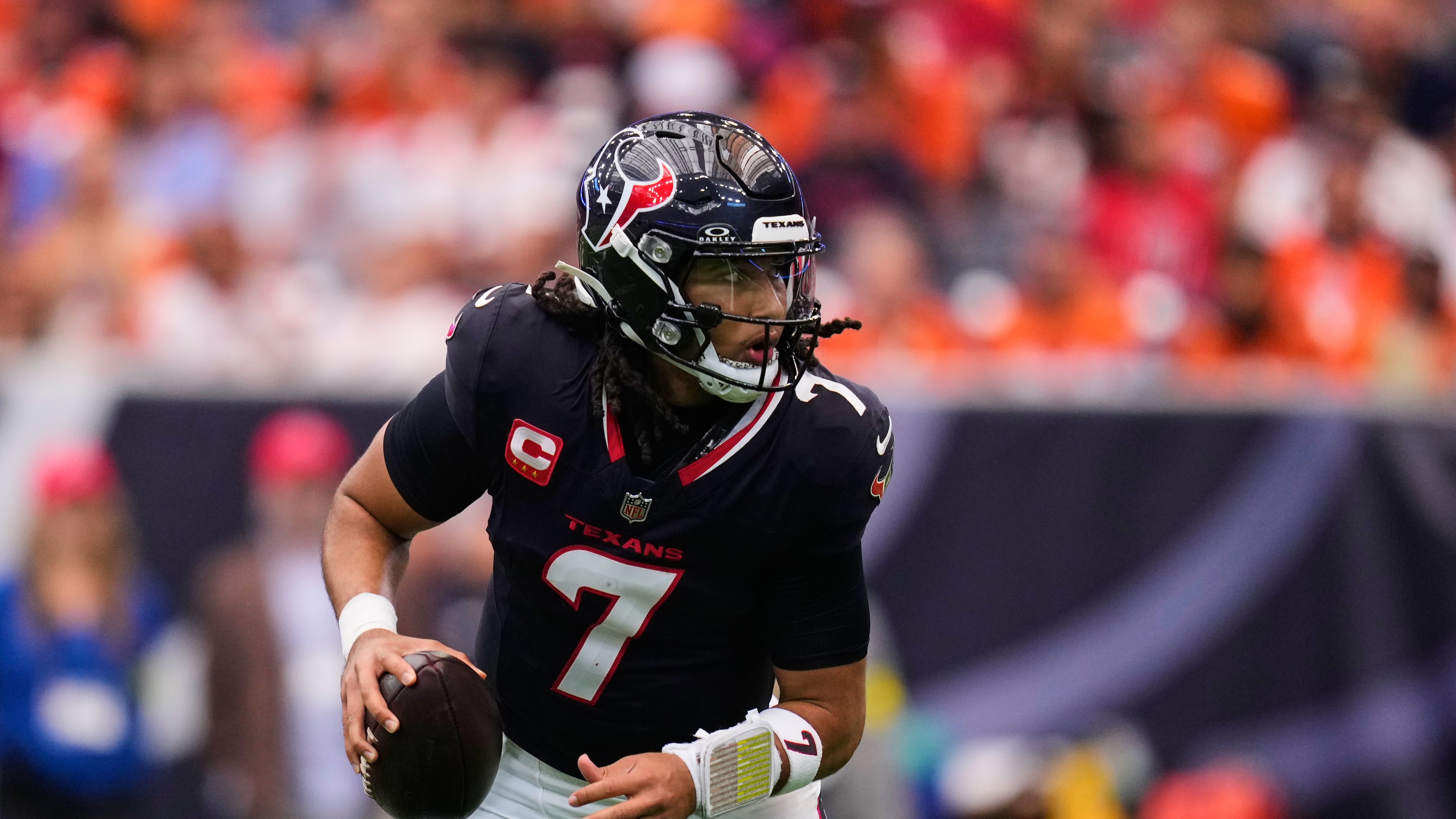Houston Texans' C.J. Stroud scrambles out of the pocket in the first half of an NFL football game against the Denver Broncos Sunday, Nov. 2, 2025, in Houston. (AP Photo/Eric Christian Smith)