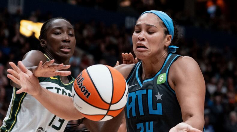 FILE - Atlanta Dream's Brionna Jones (24) fights for the ball against Seattle Storm's Ezi Magbegor (13) during the second half of a WNBA basketball game in Vancouver, British Columbia, Aug. 15, 2025. (Ethan Cairns/The Canadian Press via AP, File)